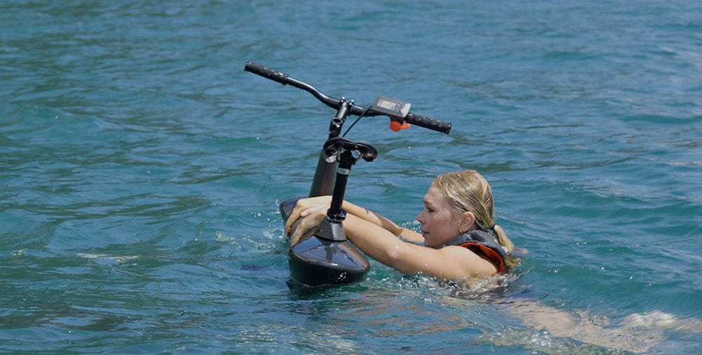 Girl on the water preparing to launch the Hydrofoiler SL3 water-bike