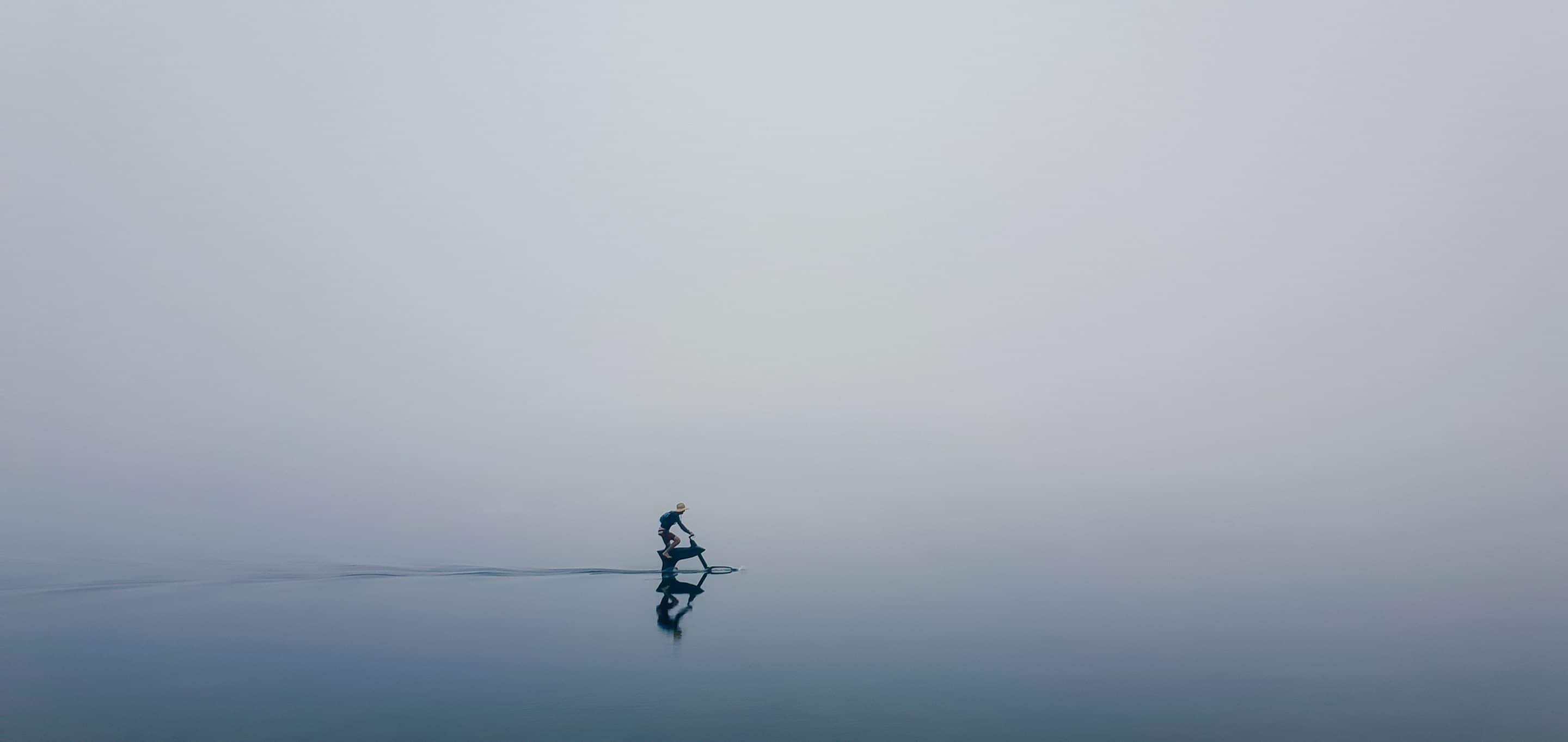 Male Riding a hydrofoiler SL3 water bike in a foggy Lake