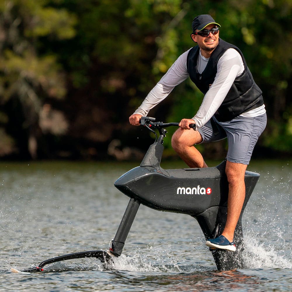 Man riding the Hydroifoiler SL3 pro water bike on a lake