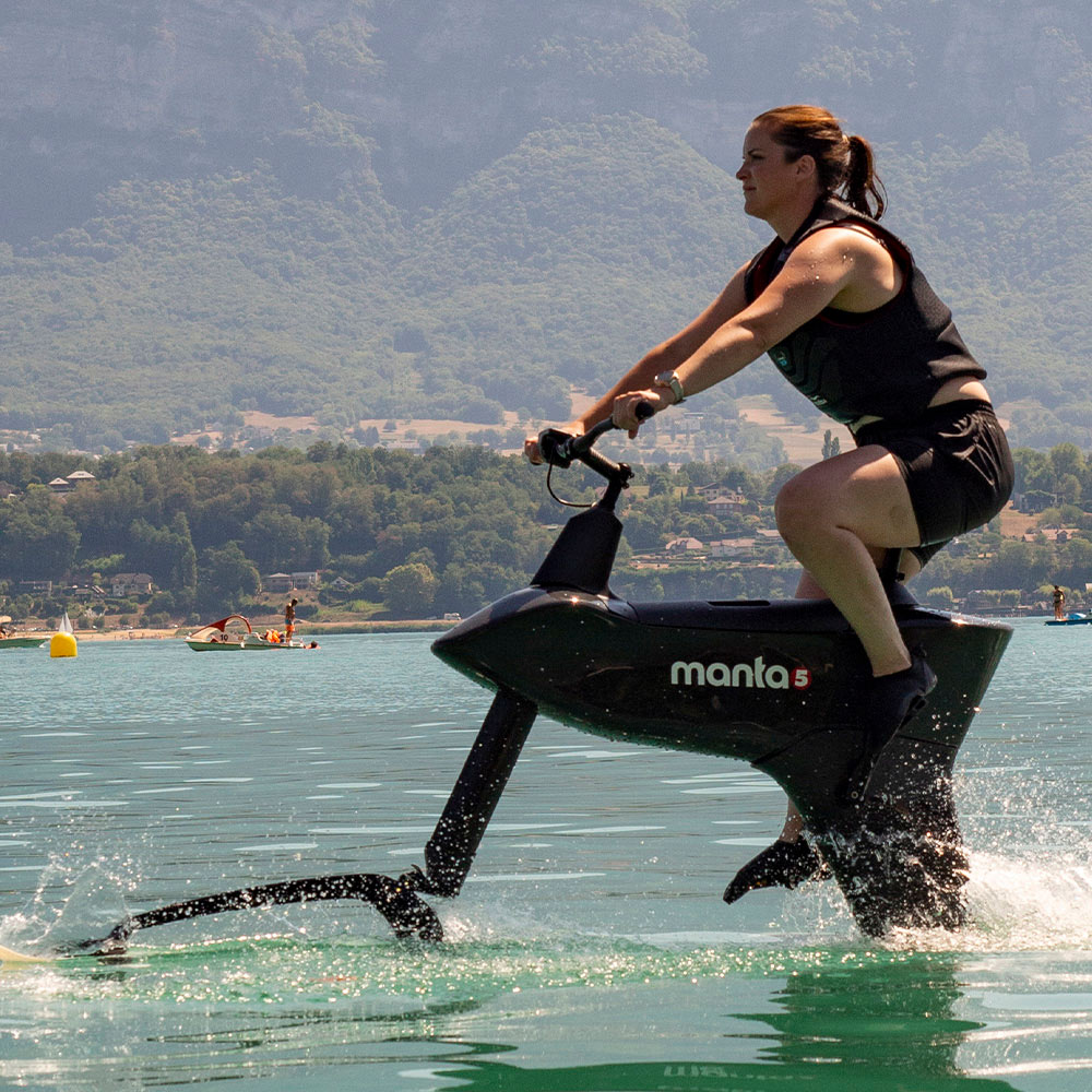 Side view of a girl Riding the Hydrofoiler SL3 water bike on a Lake