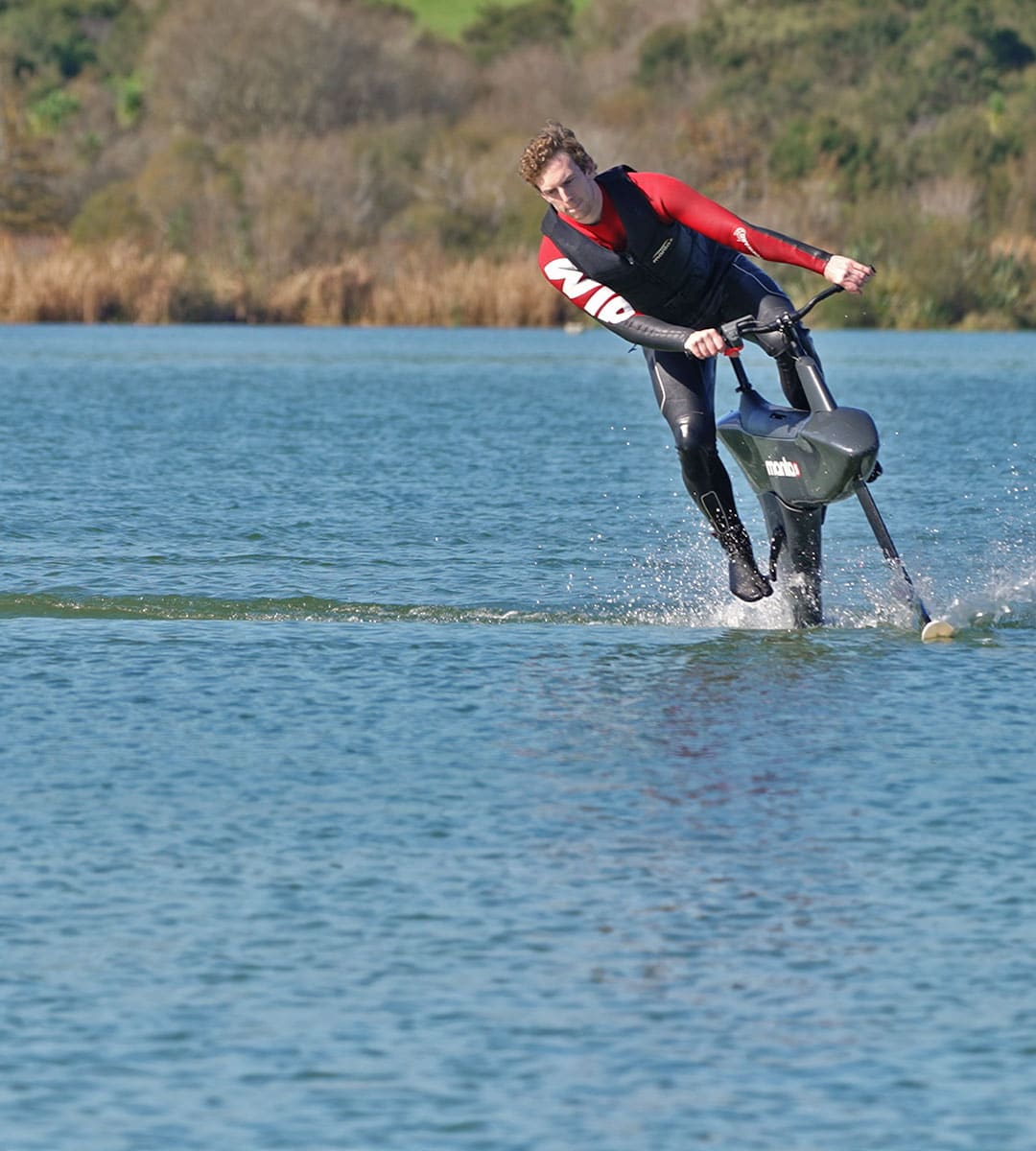 Man taking a turn while riding the hydrofoiler SL3  water bike on a lake